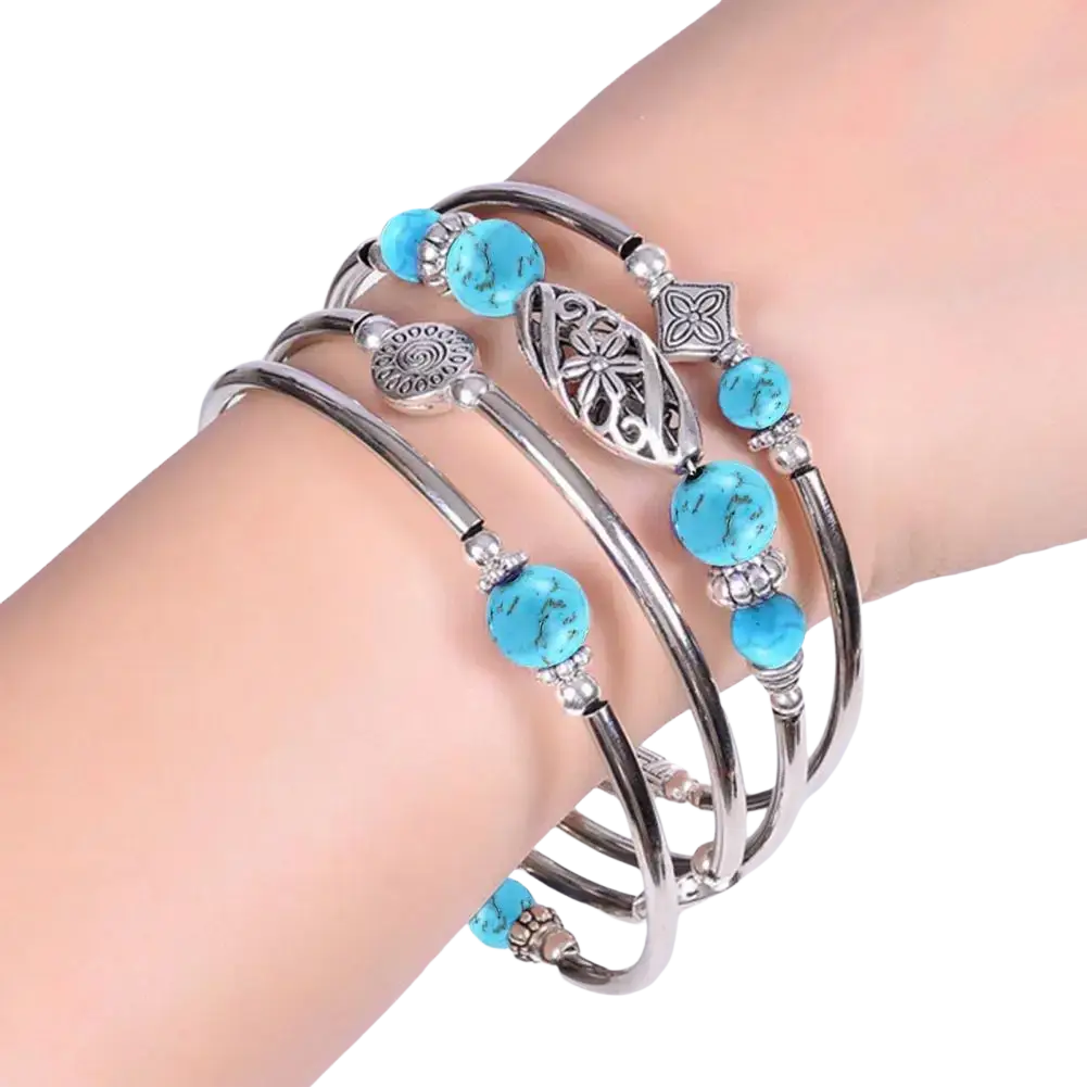 A set of four silver-toned women bangles with natural turquoise stones and intricate metal charms multi layered bracelet