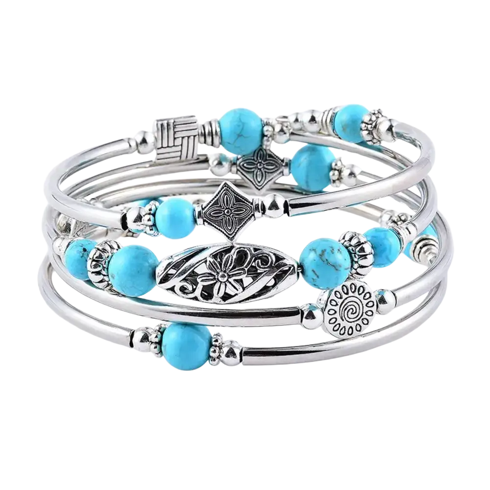 Stacked silver women bangle featuring natural turquoise stones and intricate metal charms in a multi layered design