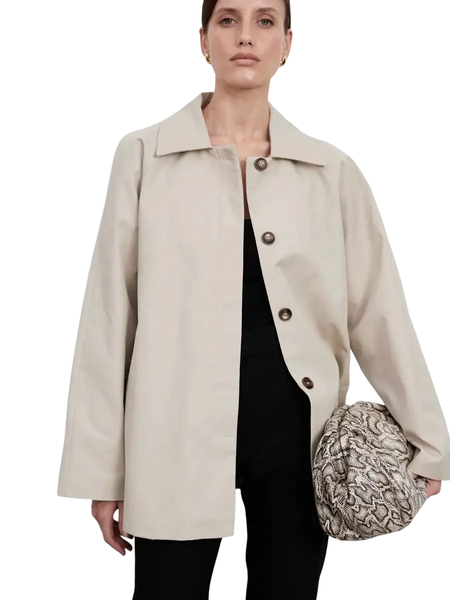Beige women belted trench coat with cape overlay featuring a structured collar and dark brown buttons