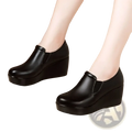 Women black wedge heel leather shoes featuring a sleek slip-on design with a comfortable platform sole