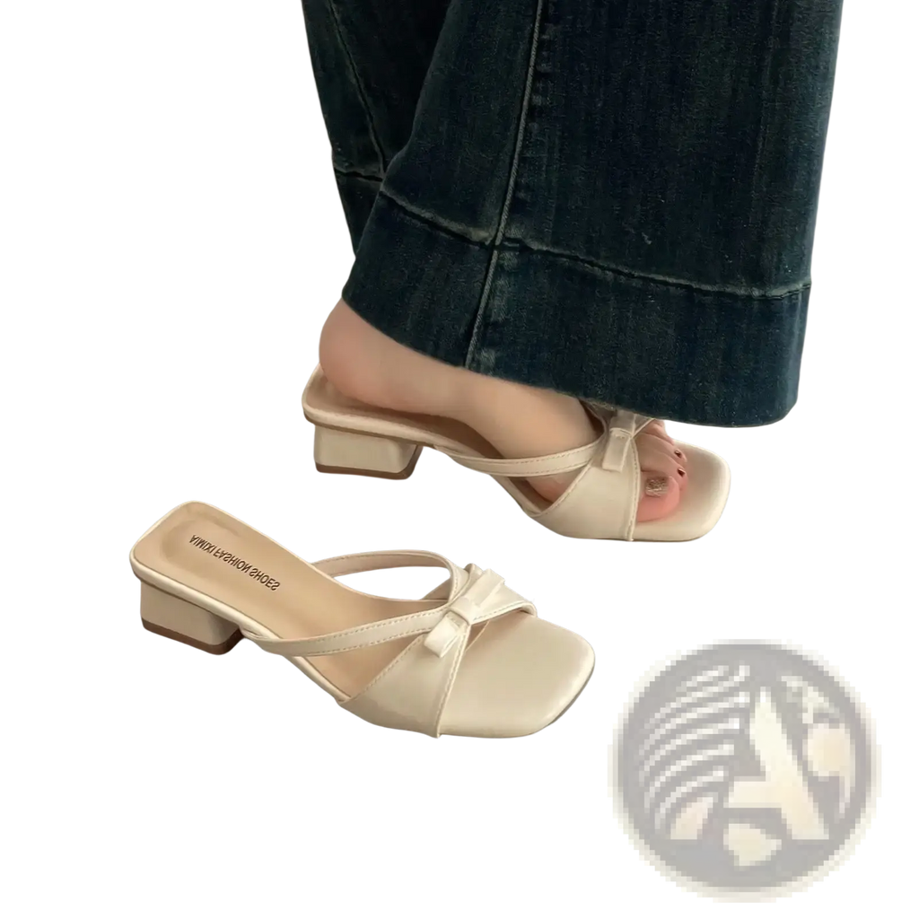 Cream-colored leather women bow mules with square toe low block heel and small bow detail on the strap