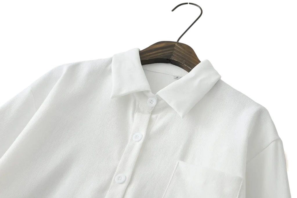 Women button down blouse long sleeve casual shirt in white with subtle texture and crisp collar hanging on wooden hanger