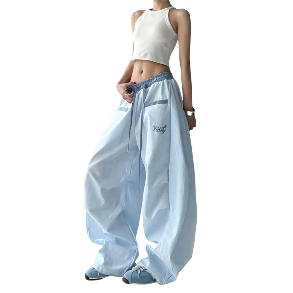Light blue loose-fitting women cargo pants with drawstring waistband and subtle embroidered branding on the thigh