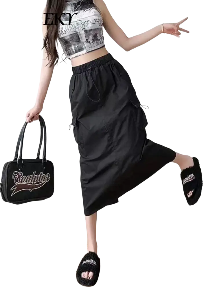 Black handbag with white sculptor logo and swoosh design paired with women cargo utility maxi skirt visible from front