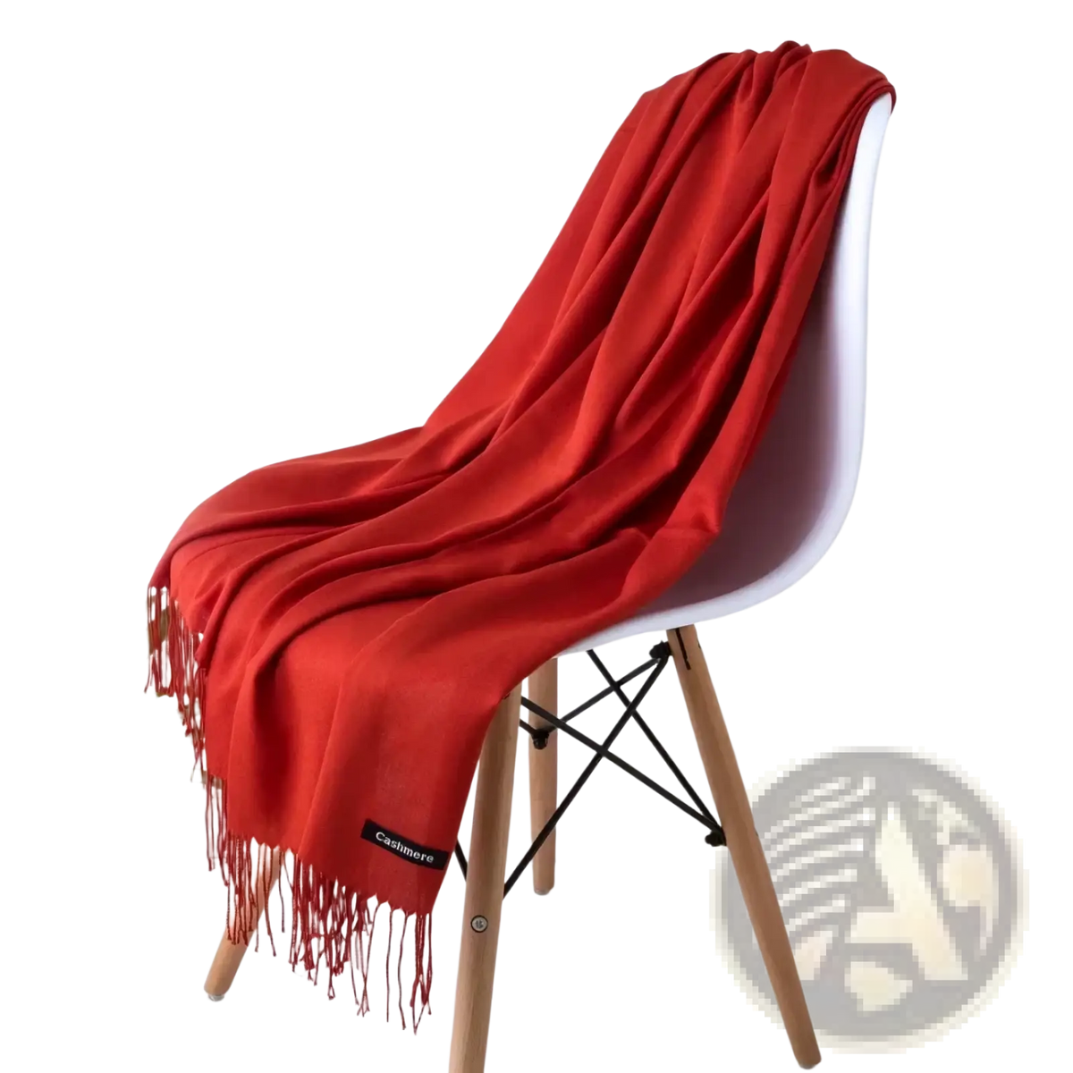 A vibrant red women cashmere feel winter scarf shawl with delicate fringe draped over a modern white chair