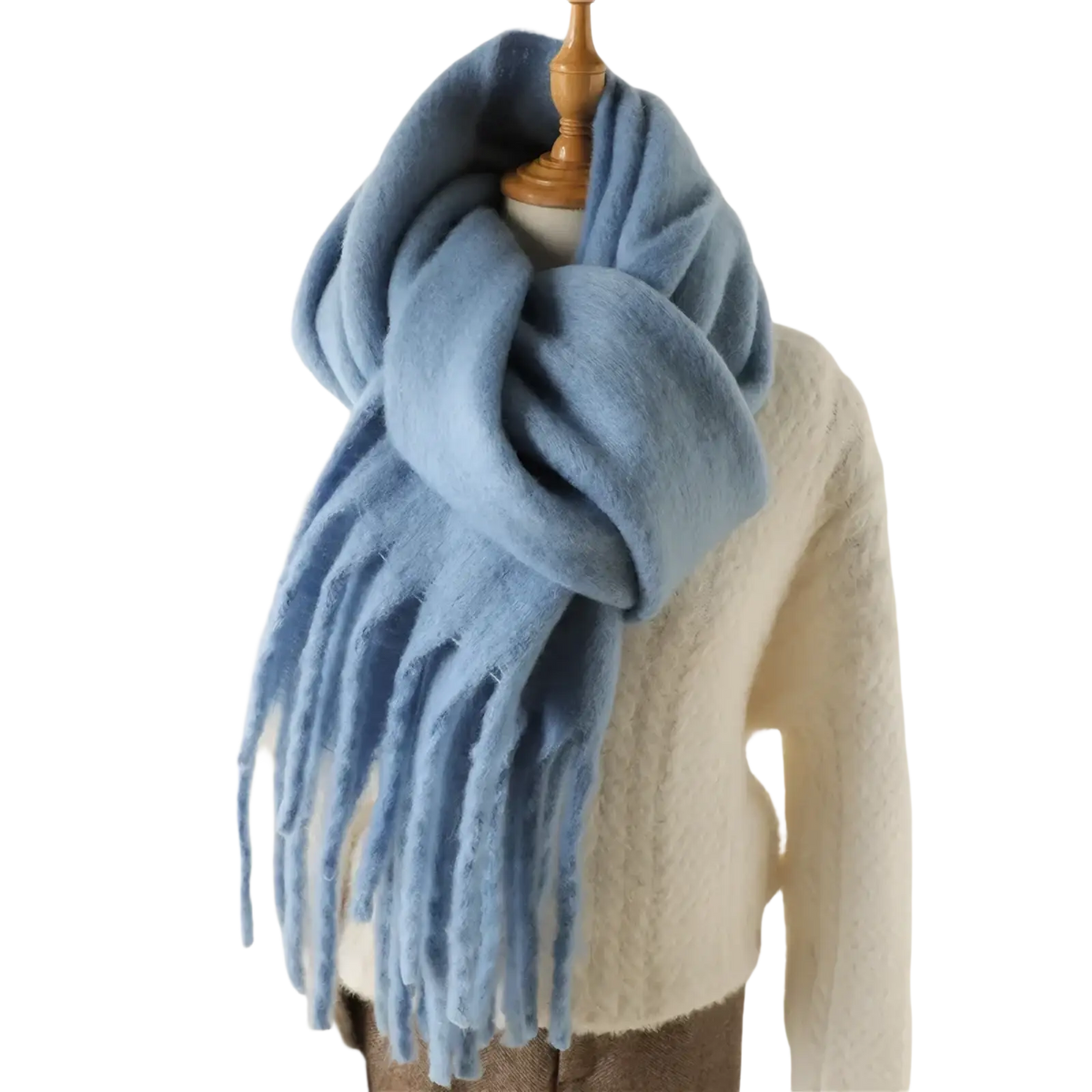A soft light blue cashmere feel winter scarf shawl with long fringed ends draped around a mannequin
