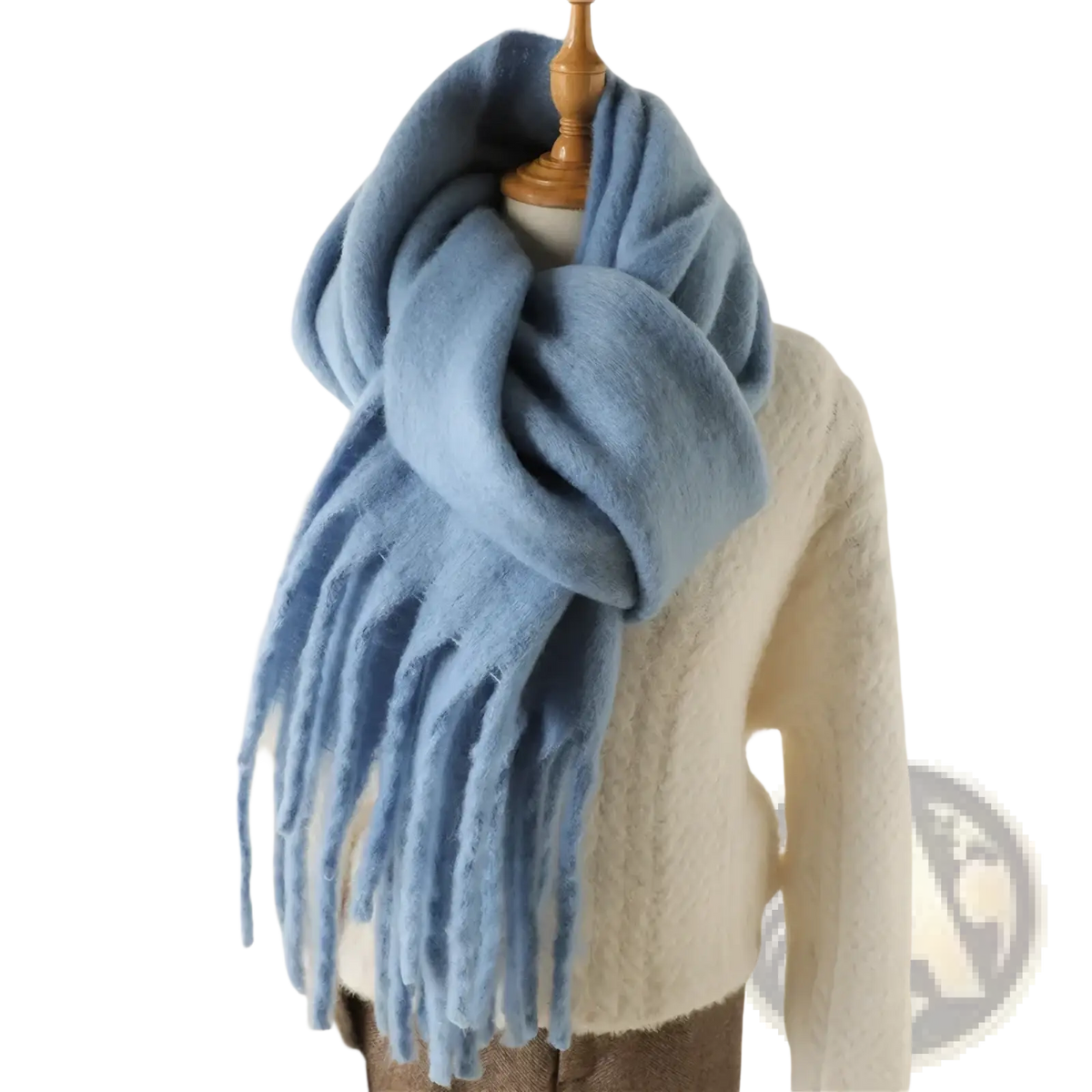 A soft light blue cashmere feel winter scarf shawl with long fringed ends draped around a mannequin