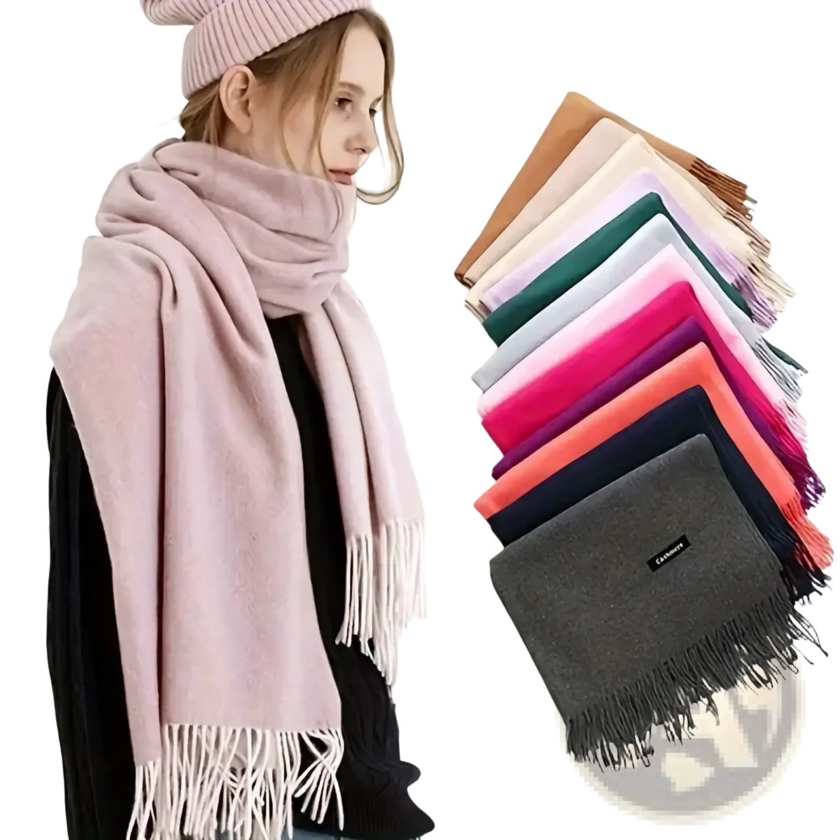 A soft pink cashmere feel winter scarf with white fringe displayed with a stack of colorful woolen scarves