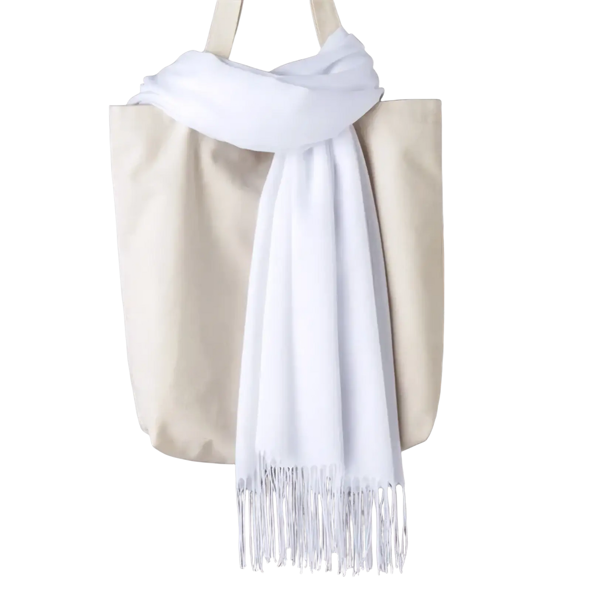 A soft white cashmere feel winter scarf shawl with delicate fringe draped elegantly over a beige tote bag