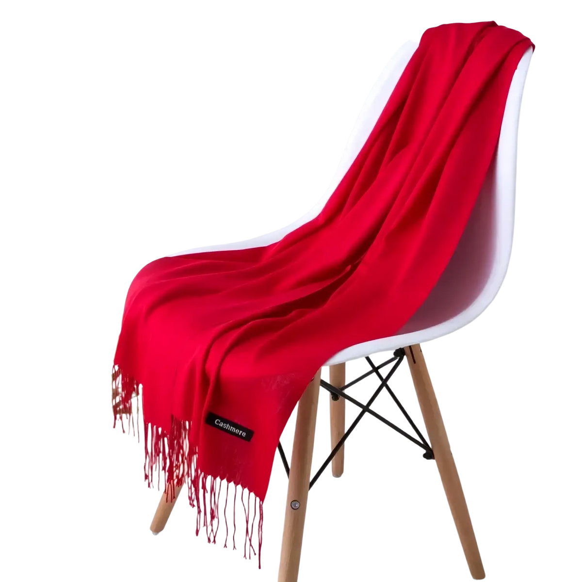 A vibrant red women cashmere feel winter scarf shawl in cashmere with delicate fringe draped on a white chair