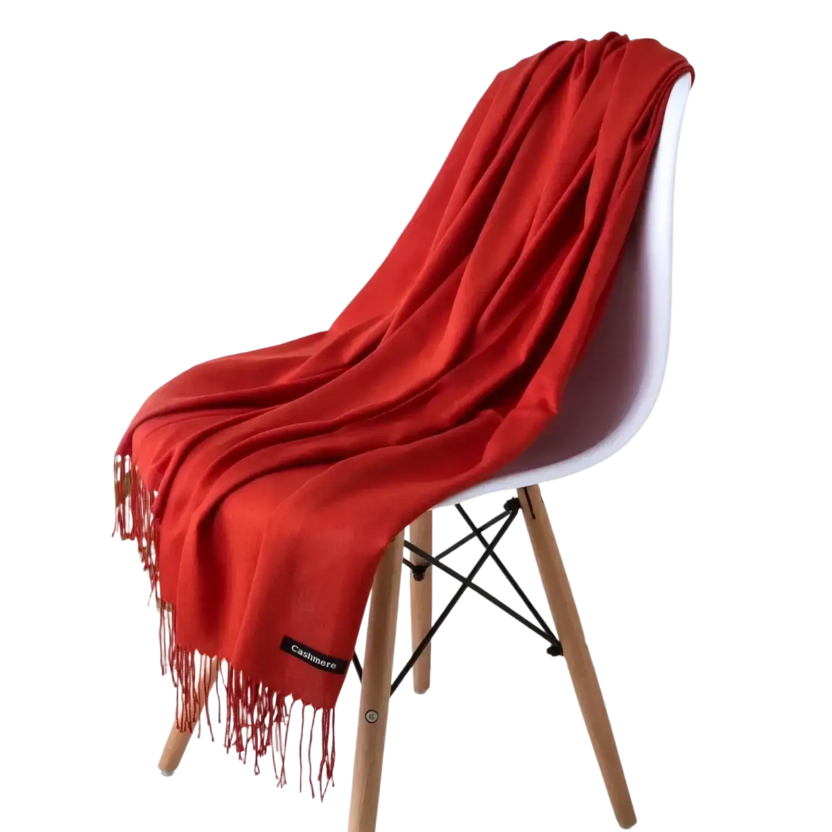 A vibrant red fringed cashmere feel winter scarf draped elegantly over a modern white chair