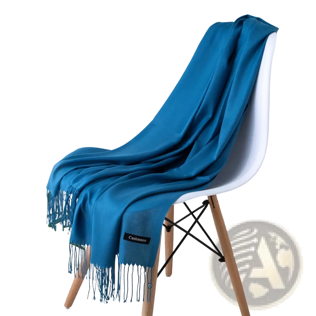 A vibrant teal cashmere feel winter scarf shawl with delicate fringe detailing and a subtle brand label