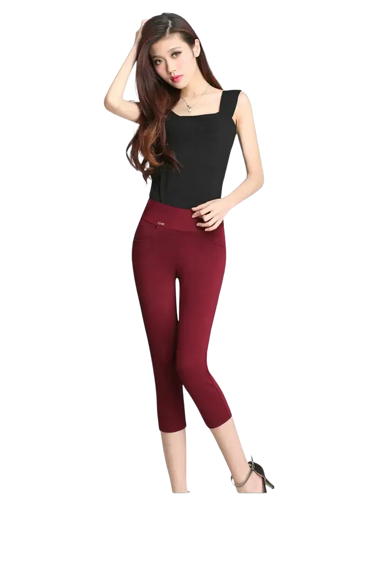 A pair of form-fitting red cotton high waisted leggings with a smooth fabric and subtle elastic waistband for workout