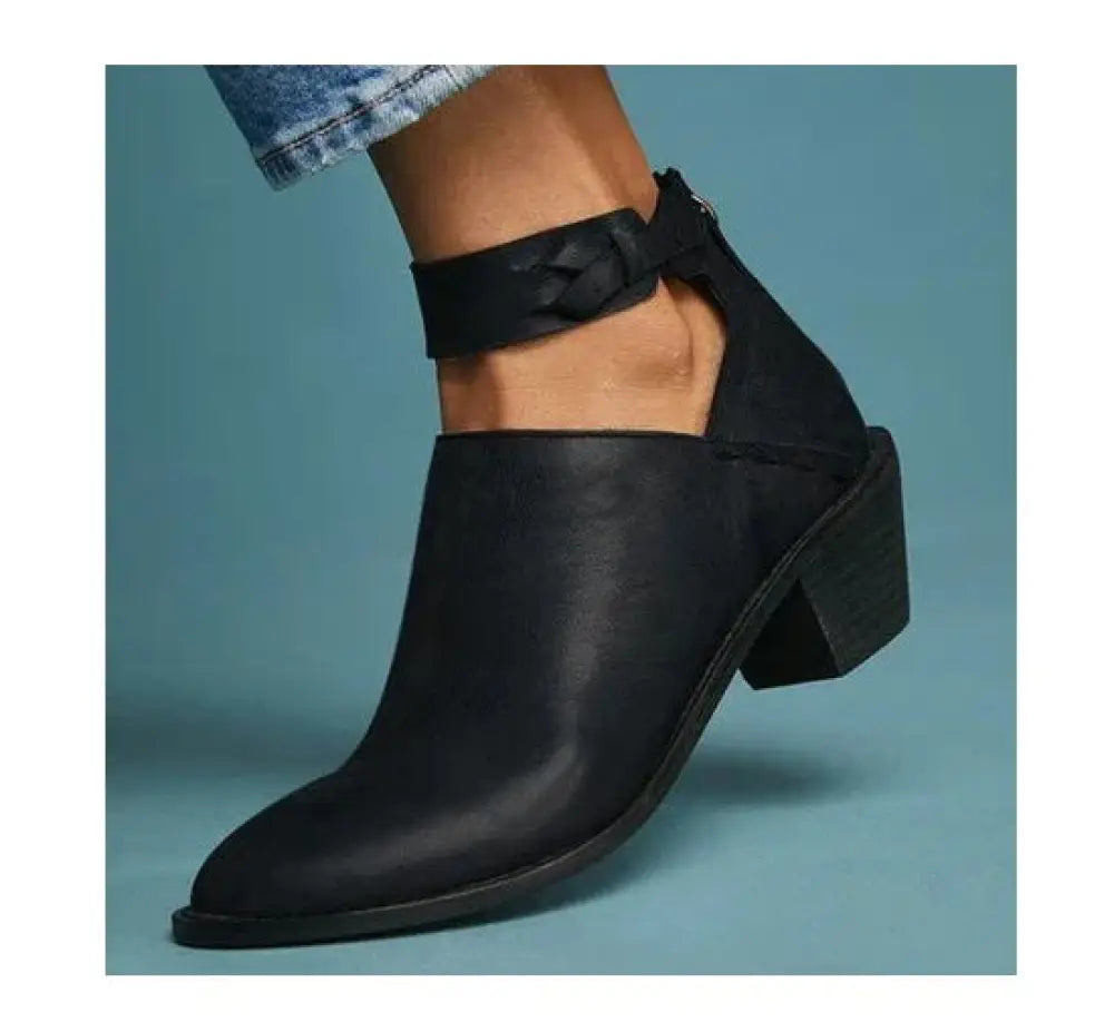Black leather women’s cut-out ankle boot with bow detail on strap and block heel showing front side
