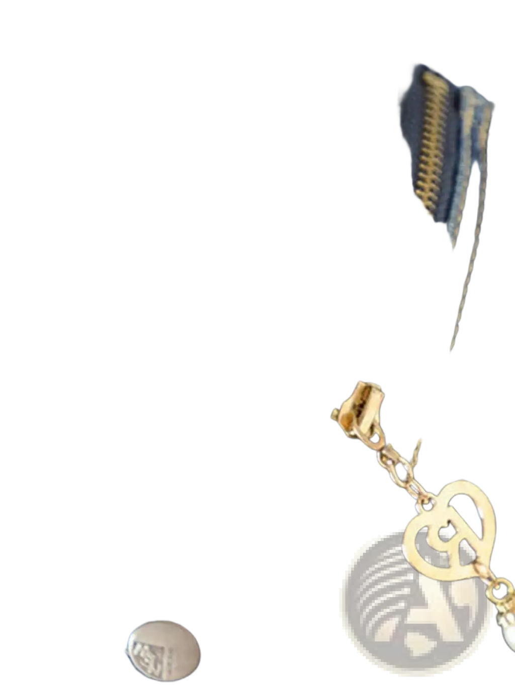 Gold-toned heart-shaped zipper pull with chain on women denim vest jacket casual sleeveless outerwear against dark blue denim