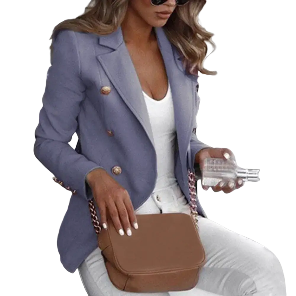 Brown leather crossbody bag with chain strap paired with women double breasted tan blazer front view
