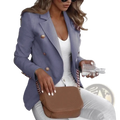 Brown leather crossbody bag with chain strap paired with women double breasted tan blazer front view