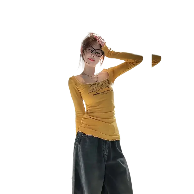 Yellow long-sleeved slim floral t-shirt with a ruched front and black text across the chest for women