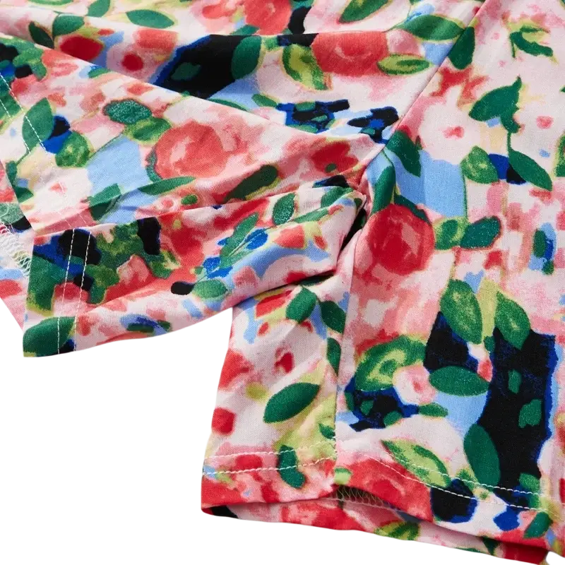 Women floral viscose lounge shorts featuring vibrant red roses green leaves and blue accents on light pink background