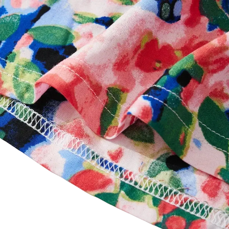 Women floral viscose lounge shorts featuring a vibrant red green blue and black bloom pattern on a light pink background