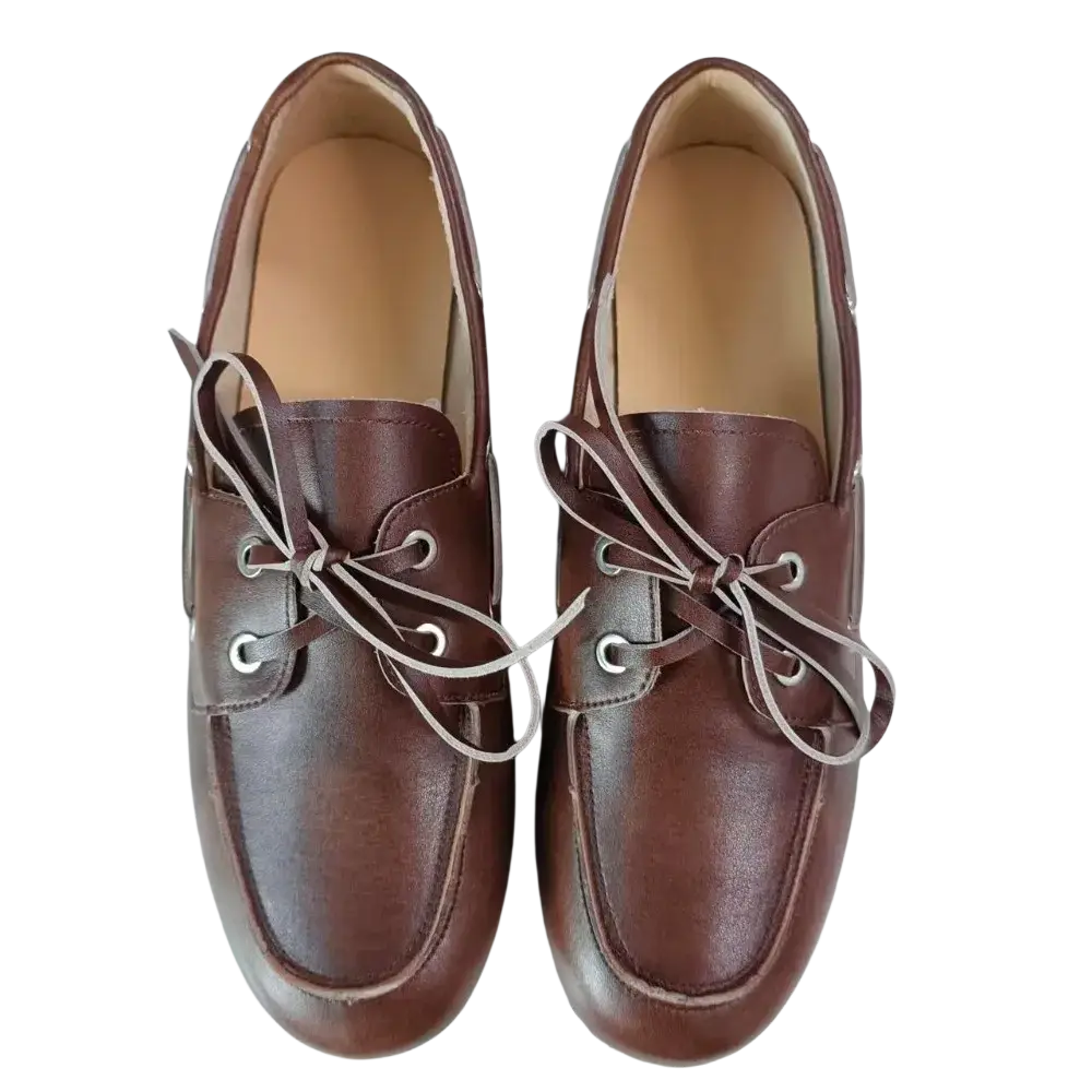 Women genuine leather boat shoes in brown with light-colored laces and silver eyelets showcasing classic craftsmanship