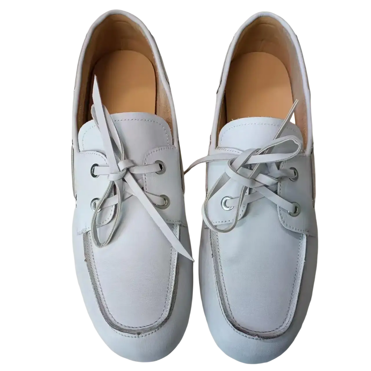 Women genuine leather boat shoes in white with matching laces and silver eyelets showcase classic loafer style