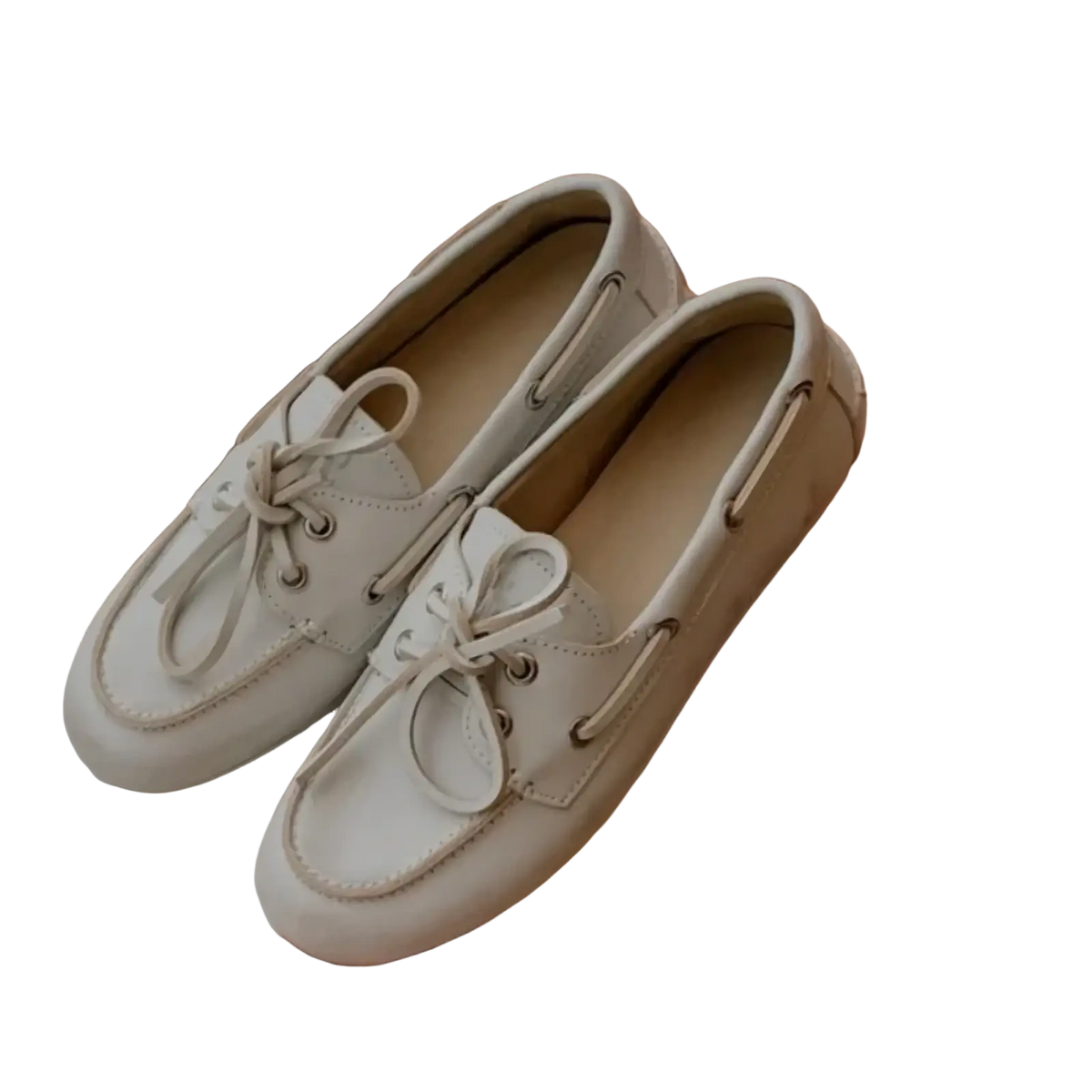 A pair of women genuine leather white lace up loafers with matching laces and silver eyelets boat shoes design