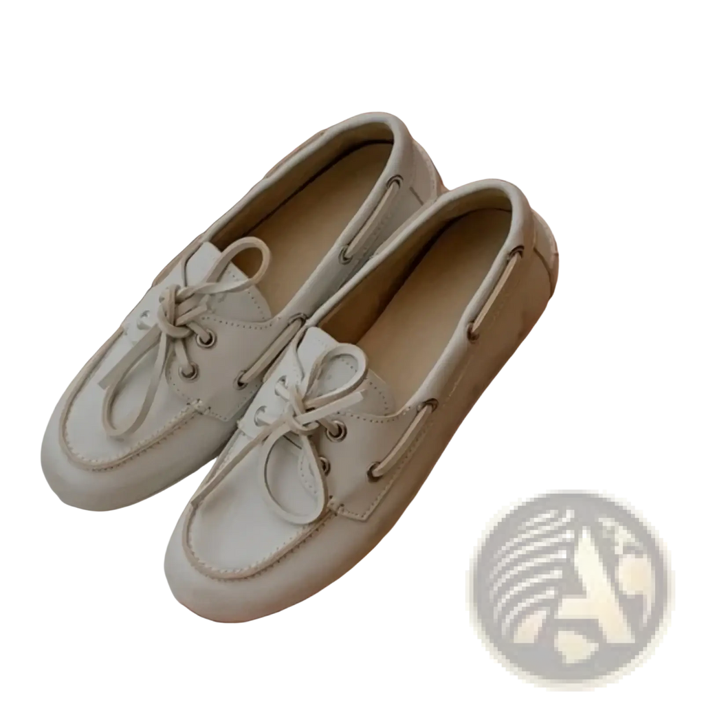 A pair of women genuine leather white lace up loafers with matching laces and silver eyelets boat shoes design