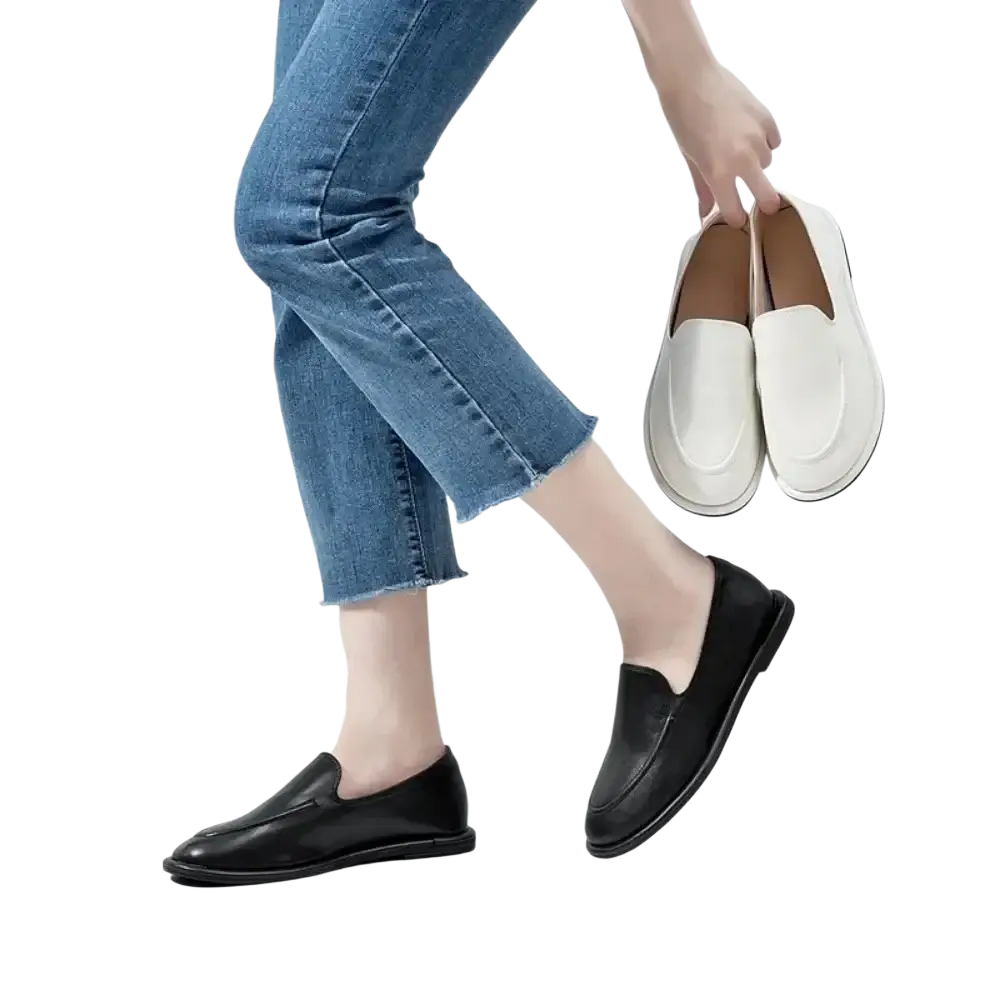 Women genuine leather slip-on flats featuring black leather with a sleek minimalist design and contrasting white soles