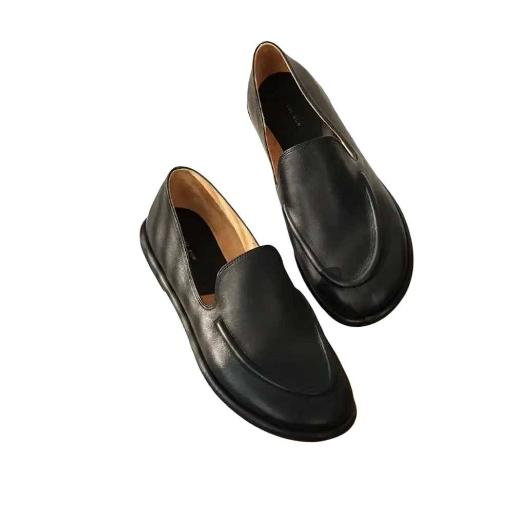 Women genuine leather slip-on flats in black with a smooth matte finish and subtle stitching details