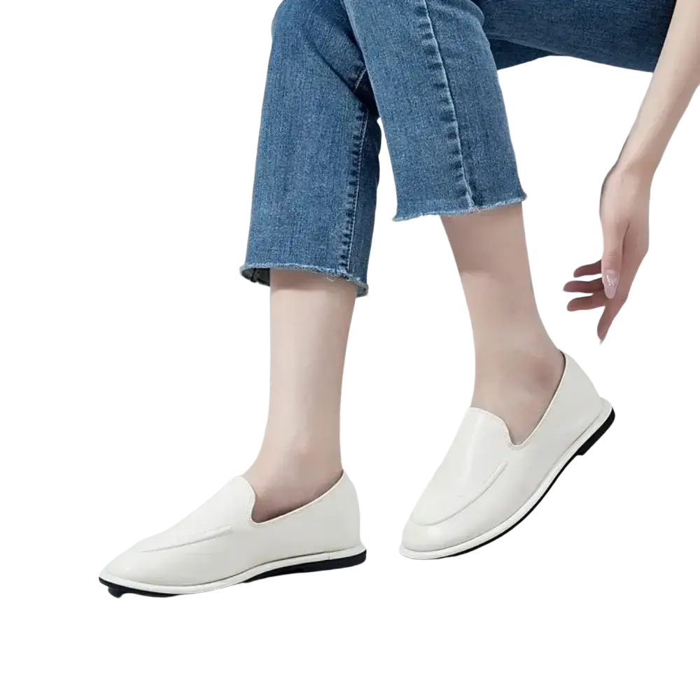 Women genuine leather slip-on flats in white with sleek minimalist design and black rubber soles for casual wear