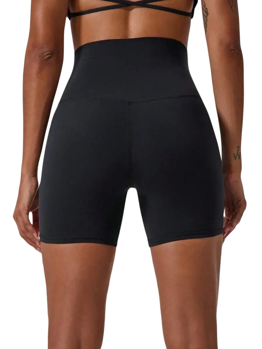 Women high waisted black stretchy athletic bike shorts with smooth fabric and flattering cross back design shown from back