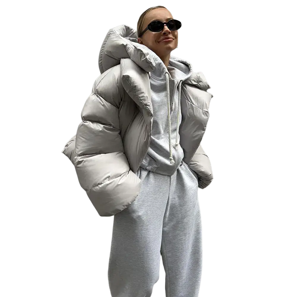 Women hooded winter puffer jacket in light gray down with quilted design and voluminous hood for cold weather