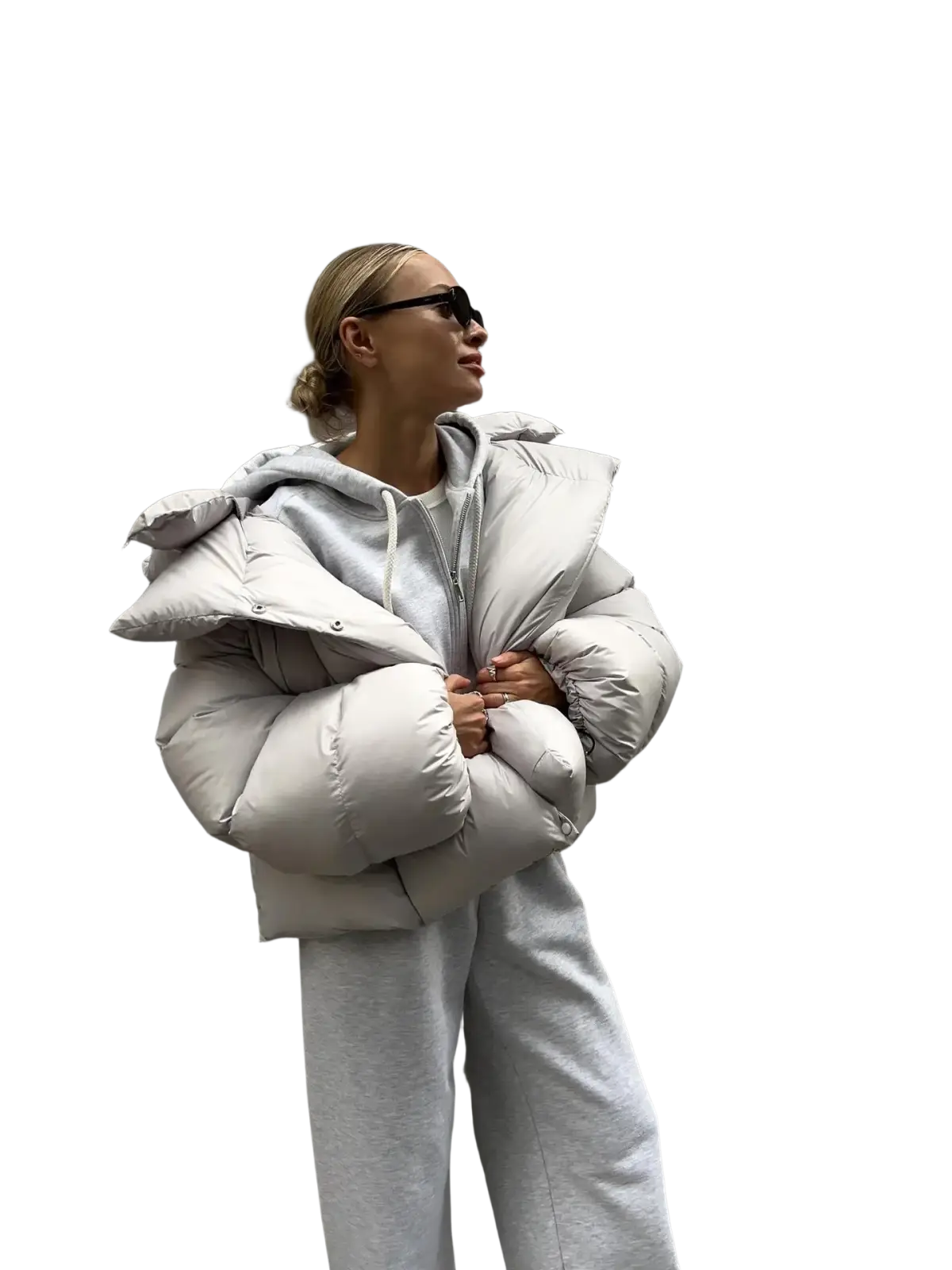 A puffy light gray quilted women hooded winter puffer jacket with button details for cold weather