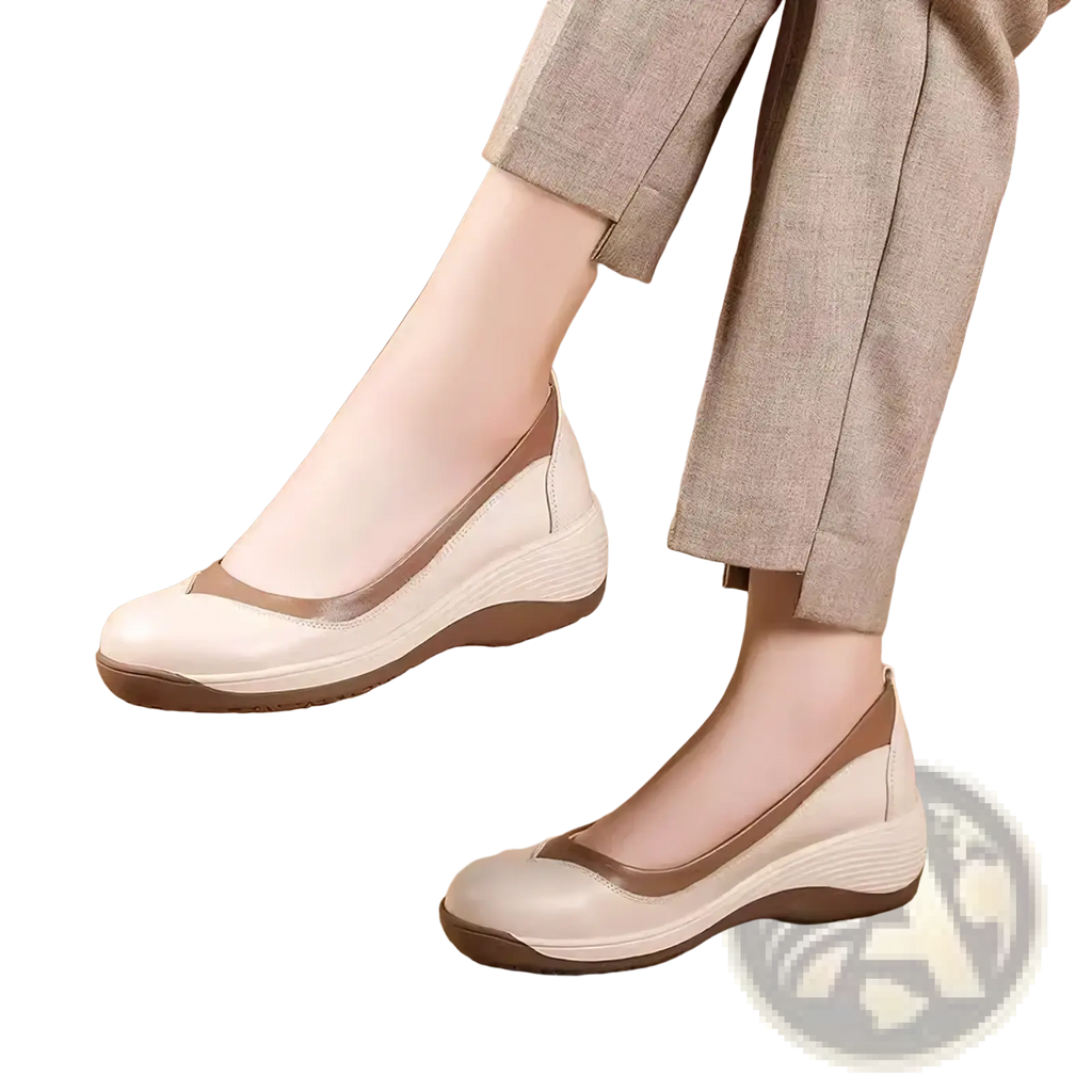 Cream-colored leather wedge flats with tan accent stripe and cushioned sole for casual slip-on wear