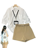White blouse with ruffled three-quarter sleeves and classic collar on wooden hanger for spring summer casual wear