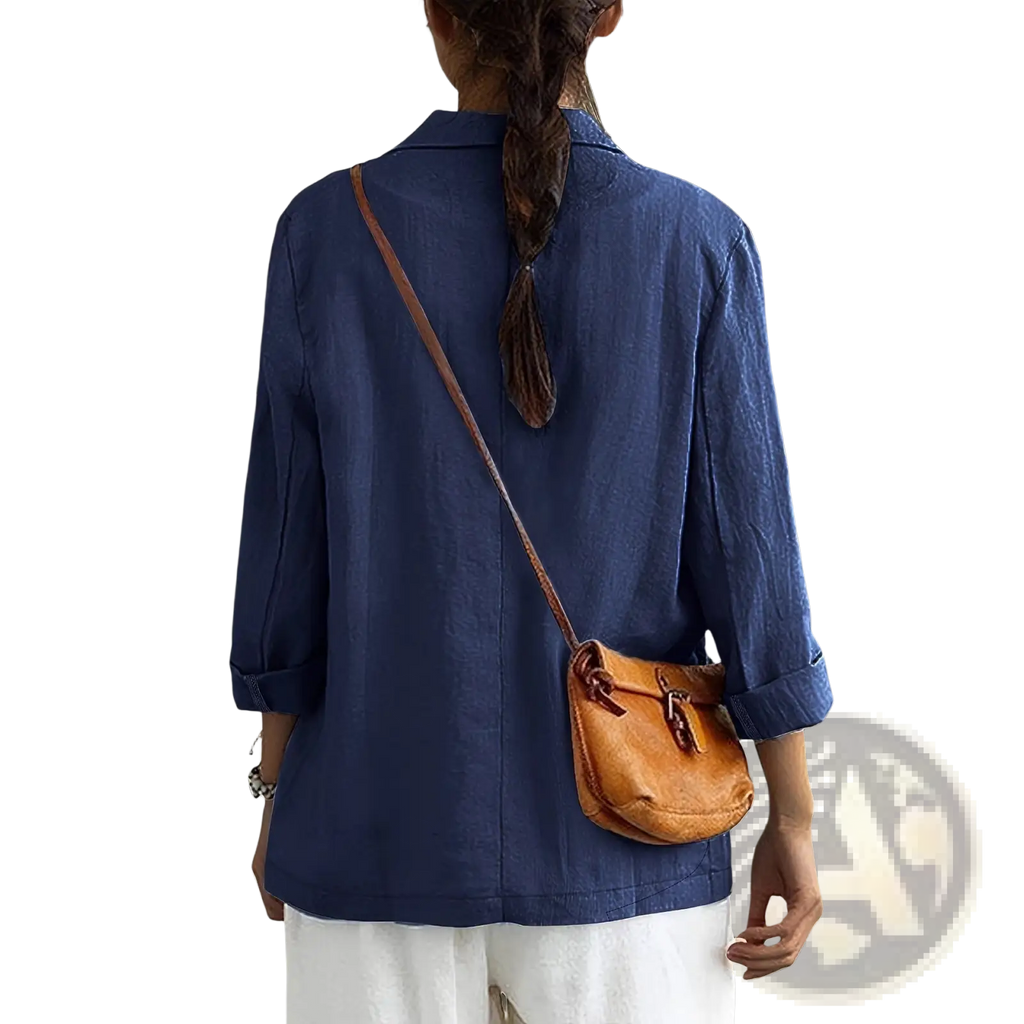 Tan leather crossbody bag with flap closure and adjustable strap paired with women linen blazer casual workwear jacket