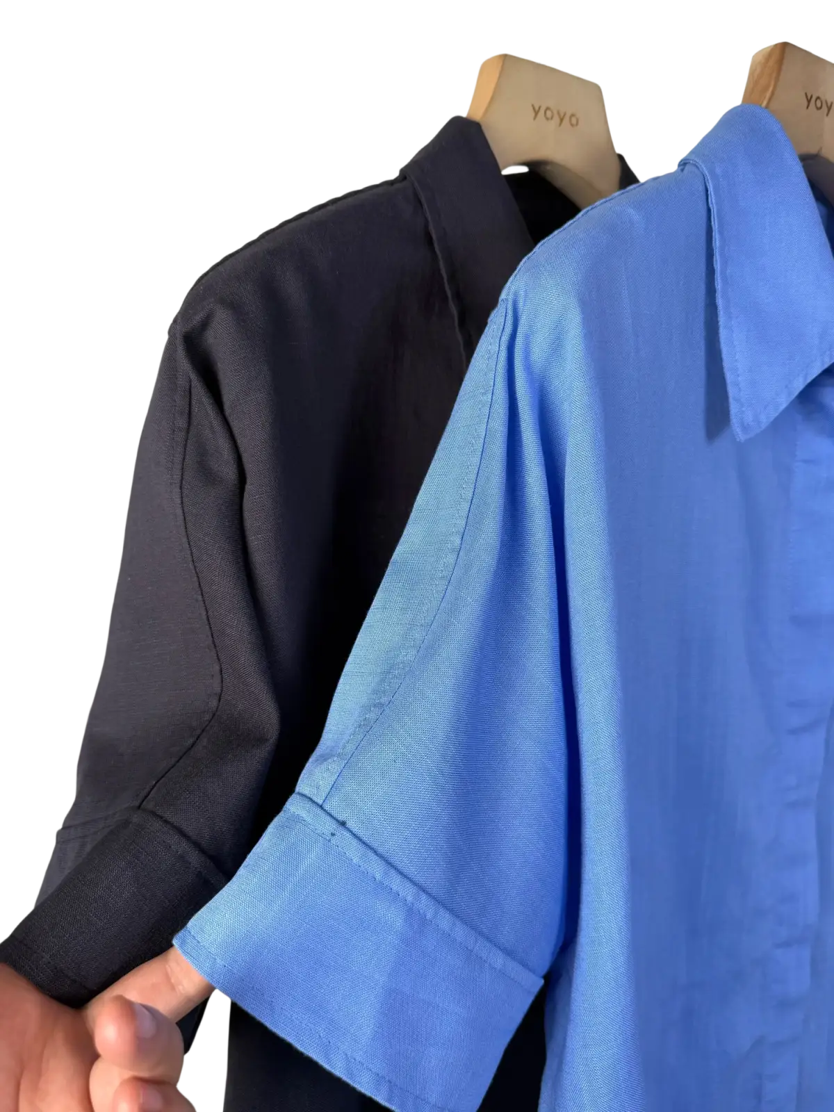 A crisp blue women linen short sleeve button up shirt with subtle textured weave and folded cuffs on wooden hanger
