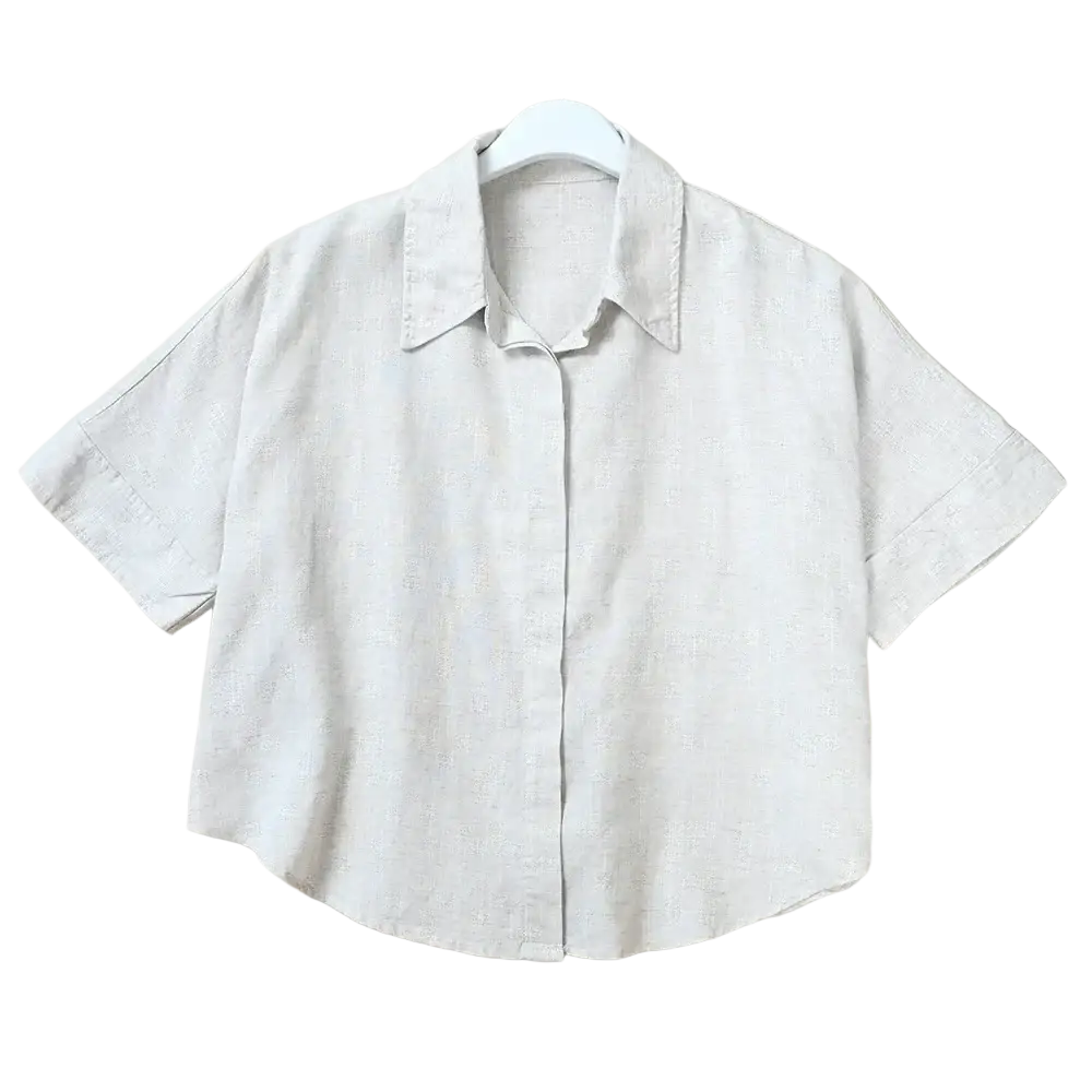 A light gray short sleeve linen button up shirt with a classic collar for women