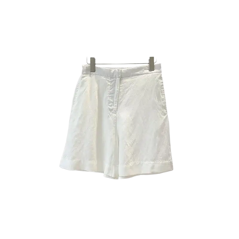 White linen shorts with subtle front pleats paired with a blue women linen short sleeve button up shirt