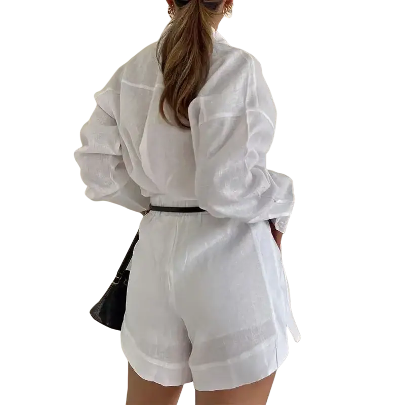 White linen jumpsuit with puffed sleeves and black belt featuring button pockets closure type details