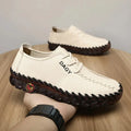 Women’s soft leather lace-up loafers in cream with black stitching and dark brown textured rubber soles