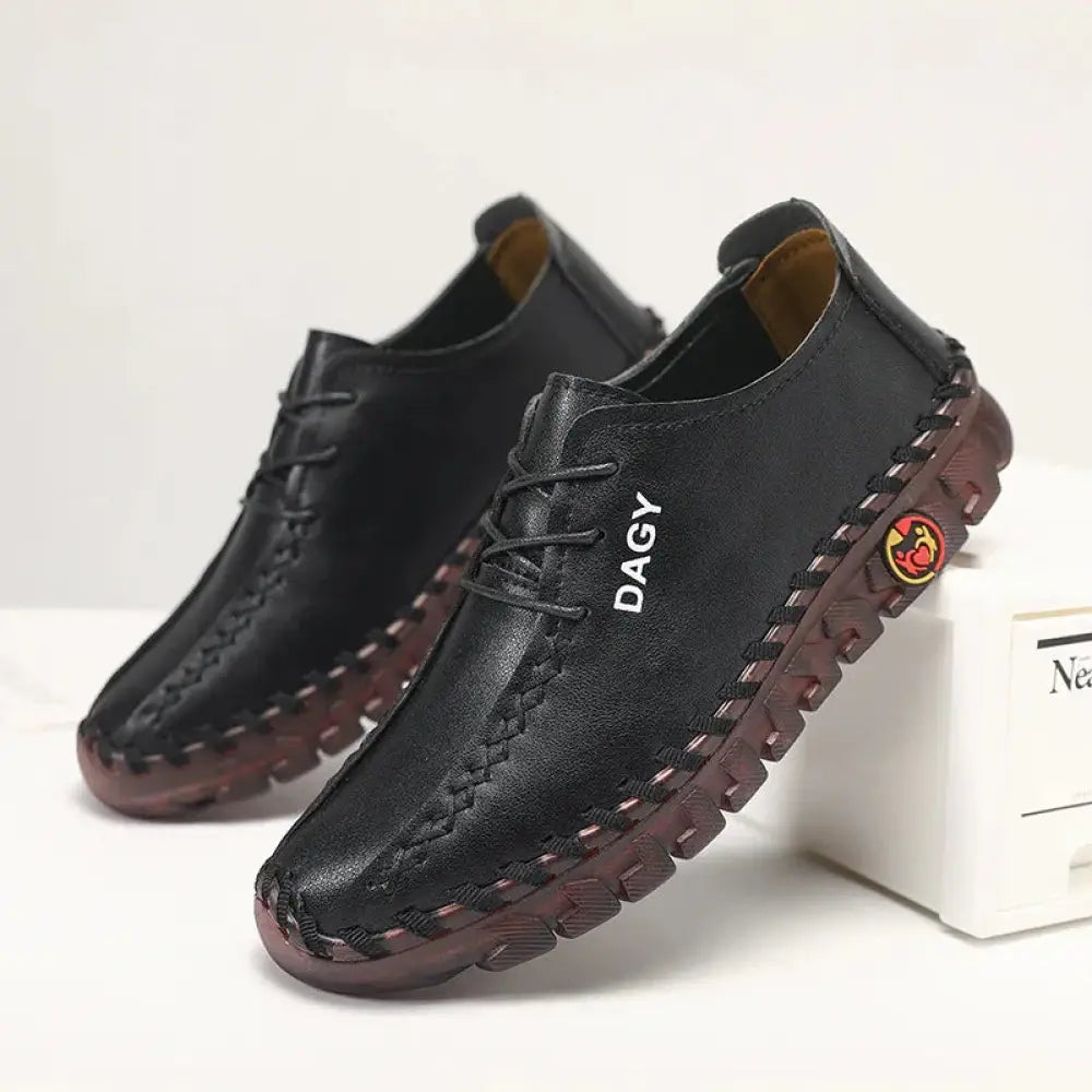 Women’s soft leather lace-up loafers in black with brown rubber soles and visible stitching details
