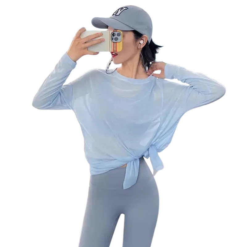 Light blue sheer women long sleeve athletic top with tied waistband and side slit for enhanced comfort