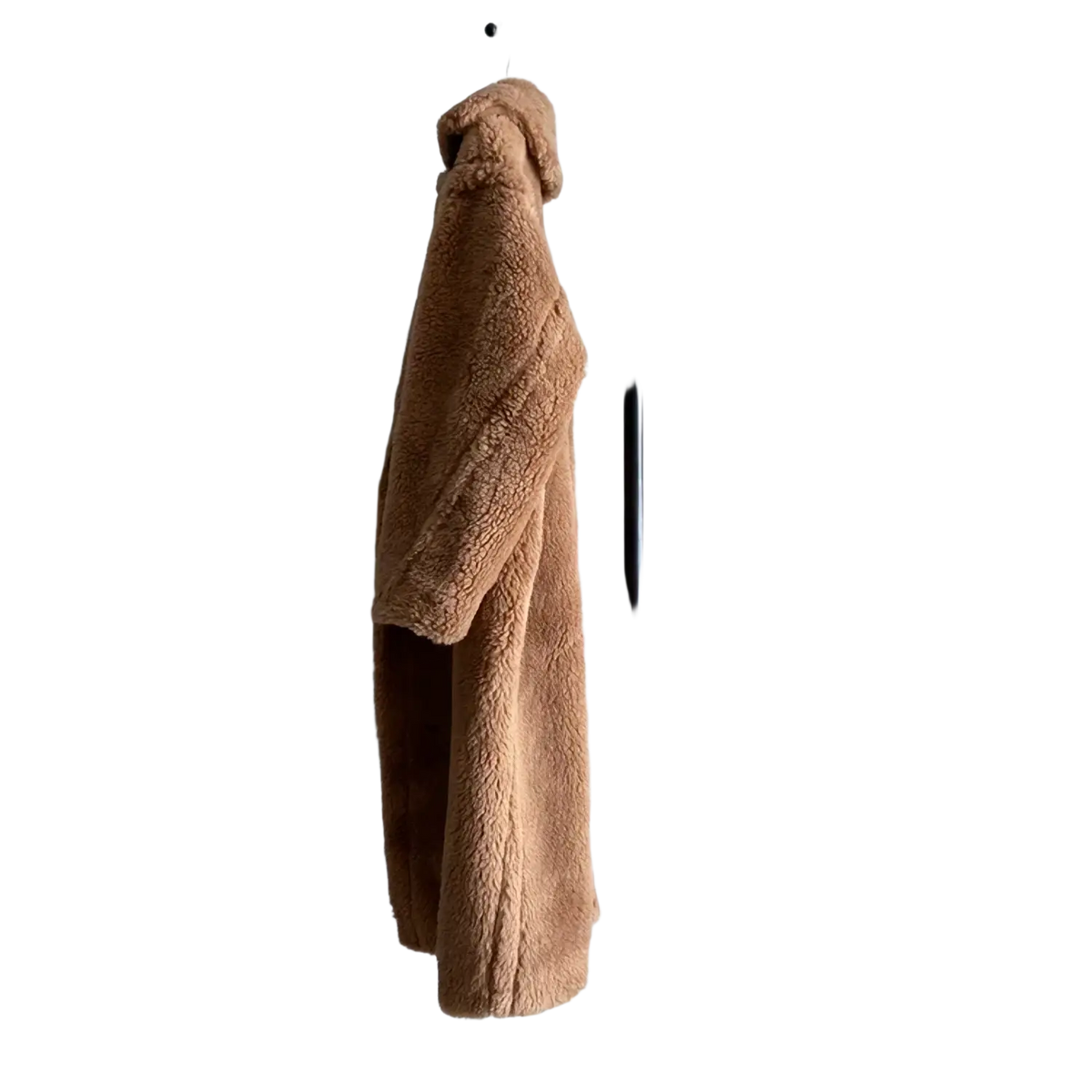 A plush tan wool women long teddy bear coat hangs on a black metal rack highlighting chest and hip circumference