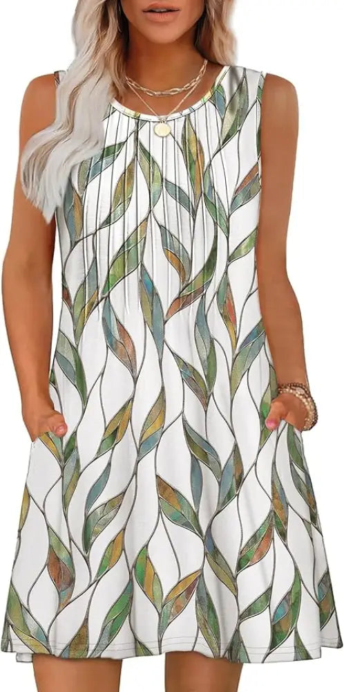 A sleeveless white loose summer beach dress with flowing green blue and brown leaf pattern for women