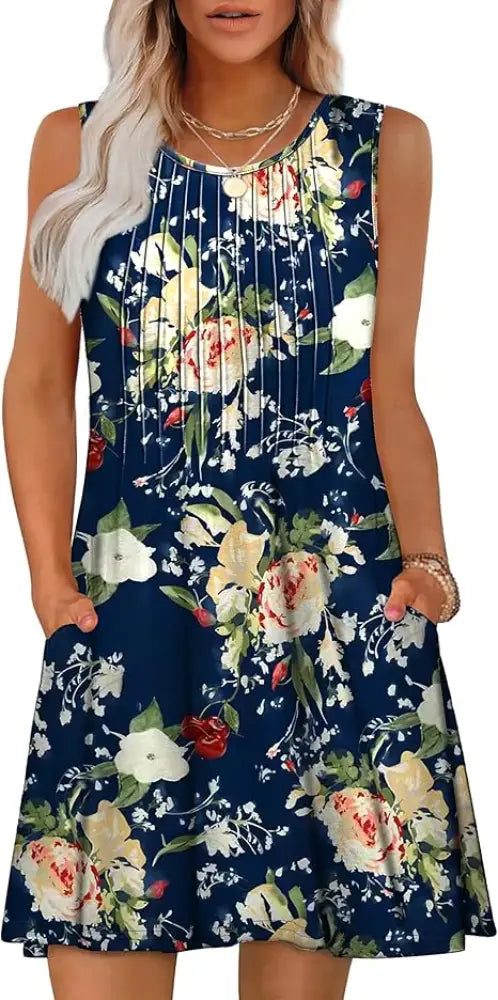 A navy blue sleeveless women’s loose summer beach dress with vibrant white yellow and red rose floral pattern and green leaves