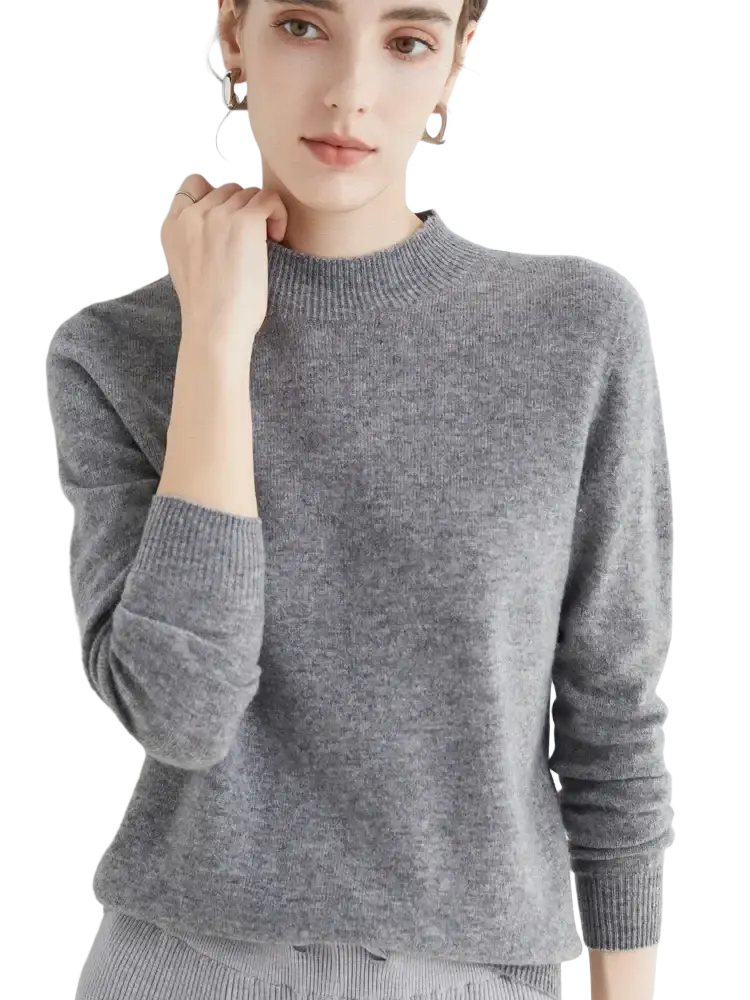 A soft heather gray cashmere sweater with a ribbed crew neckline and cuffs designed for women