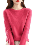 A soft vibrant pink women merino wool o-neck sweater with a textured pattern across the chest and shoulders