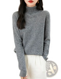 A soft heather gray women merino wool turtleneck sweater with ribbed neckline and cuffs